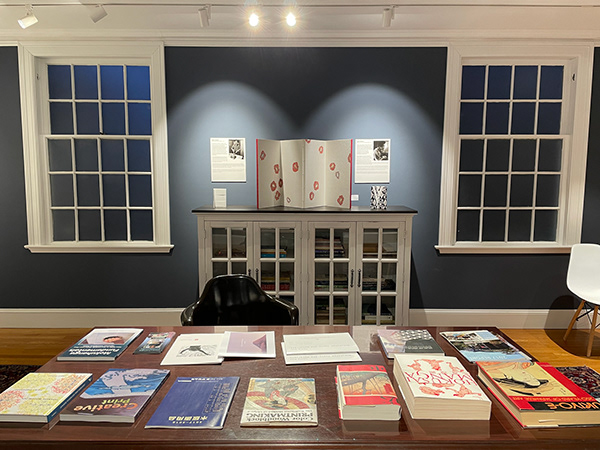 Library with books on Japanese art and mokuhanga techniques, including books by Tuula Moilanen, Terry McKenna, and April Vollmer